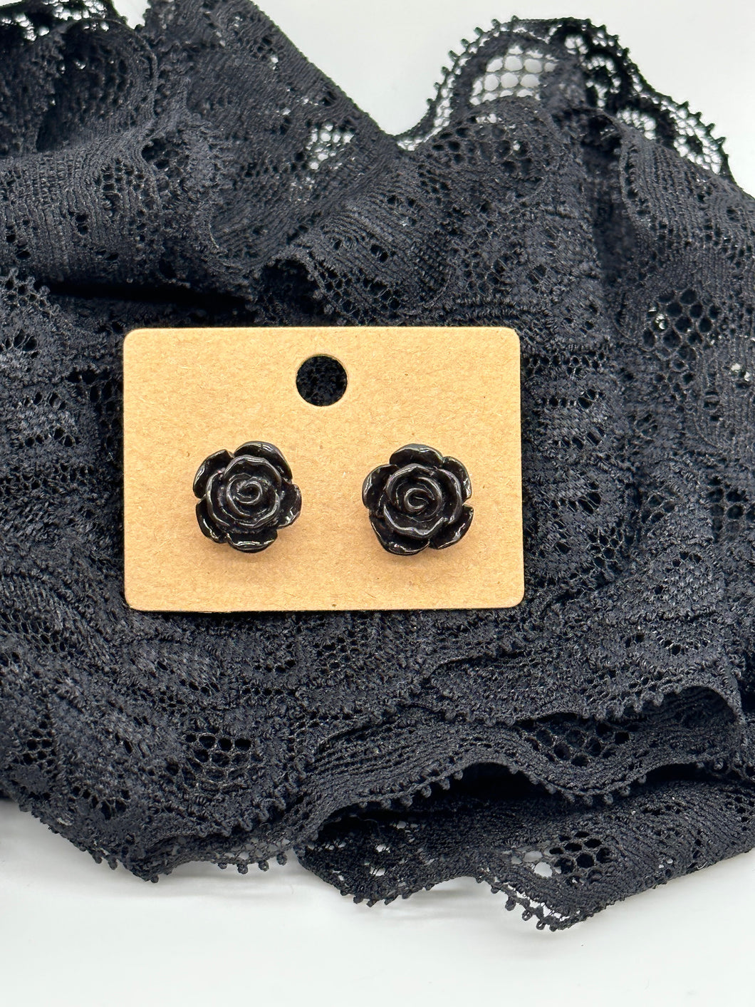 Black plastic flower stud earrings